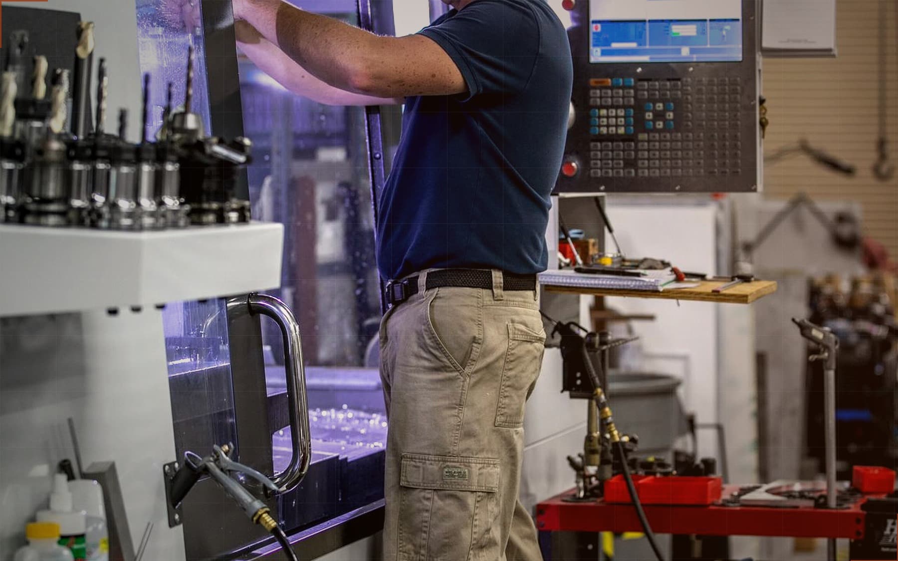 Machinist operating a CNC vertical machining center